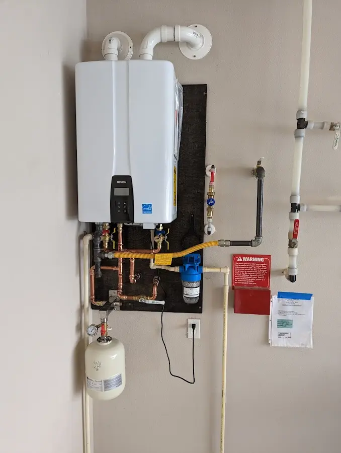 Professional plumber installing copper piping in a Sartell home